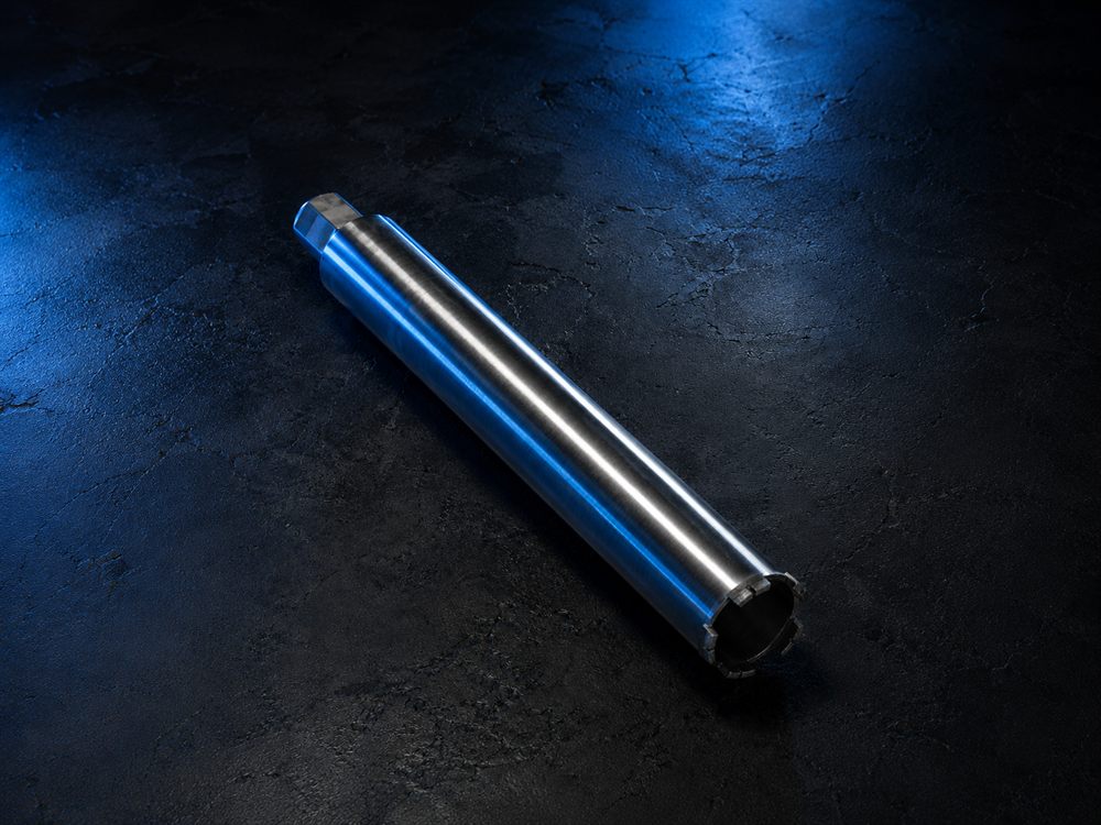 Diamond core bit product with segmented crown on a dark textured surface