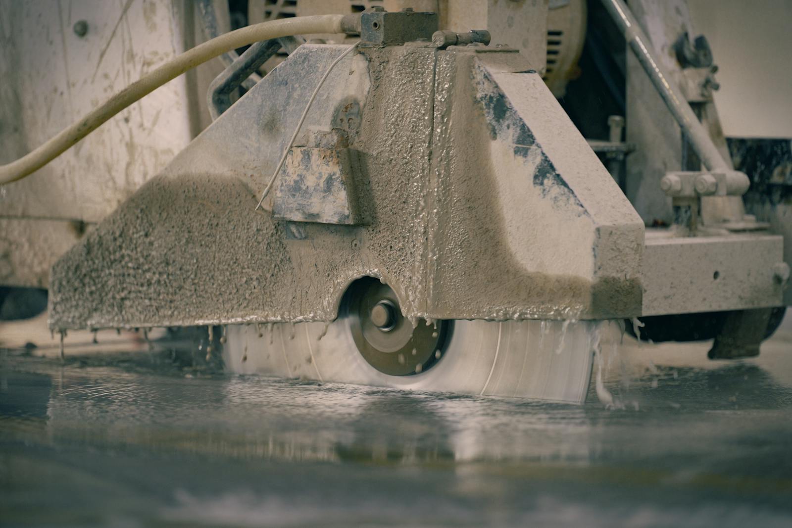 Industrial diamond saw cutting concrete with blue DTX overlay