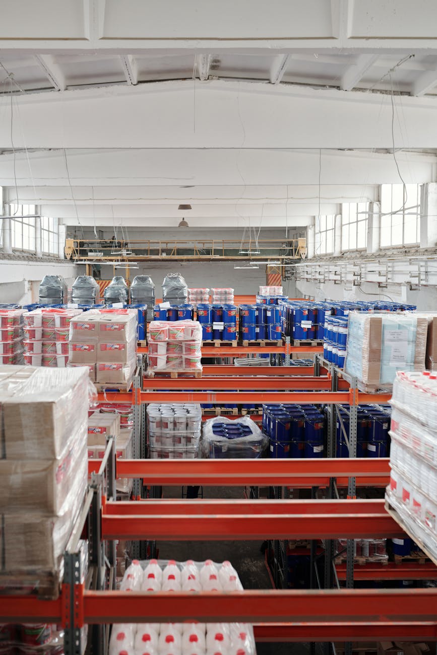 Interior of a large warehouse with neatly organized goods on shelves, ready for shipment